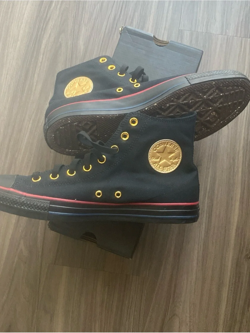 Converse mens Black High-Top Sneakers with Gold Accents and Red Stripe